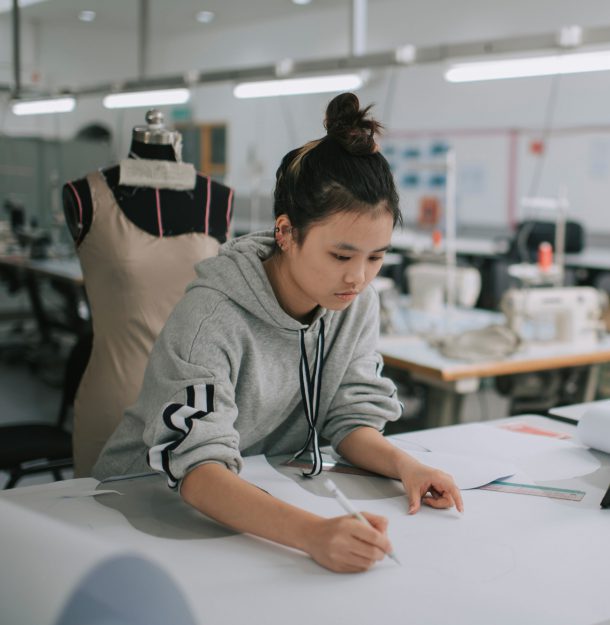 Asian woman designing clothes